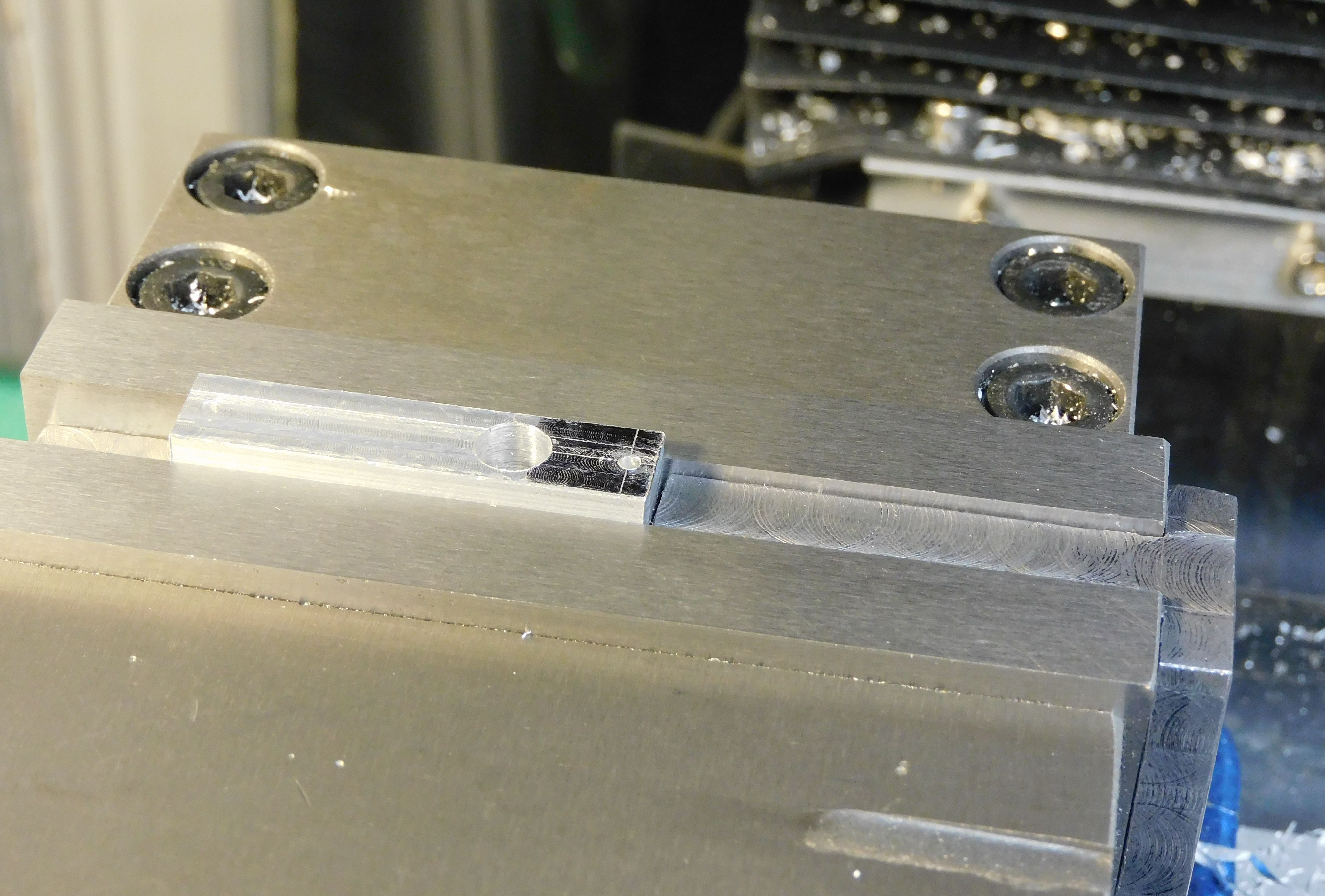 arm being drilled on the vertical mill