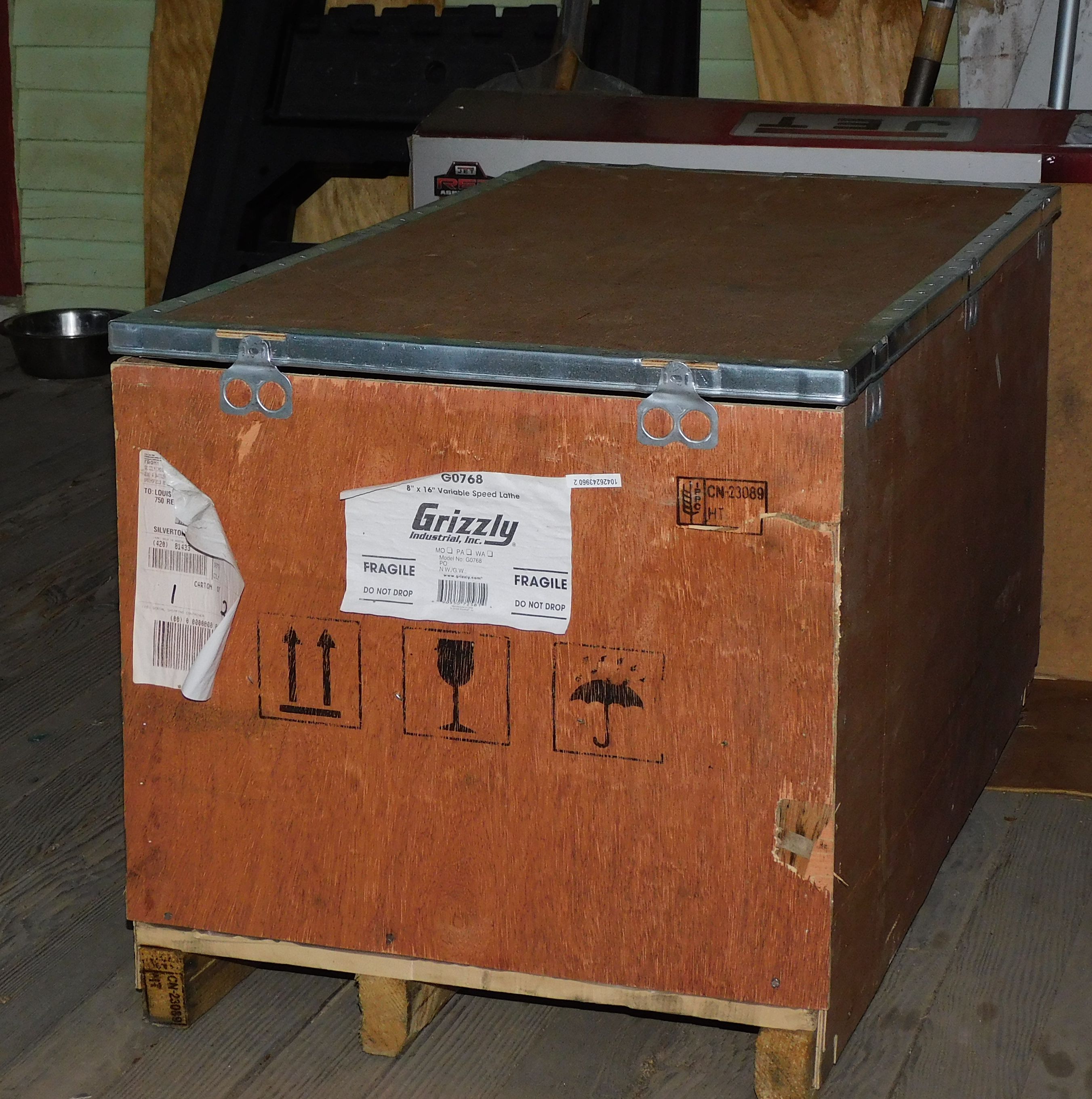 Mini lathe on porch, in crate