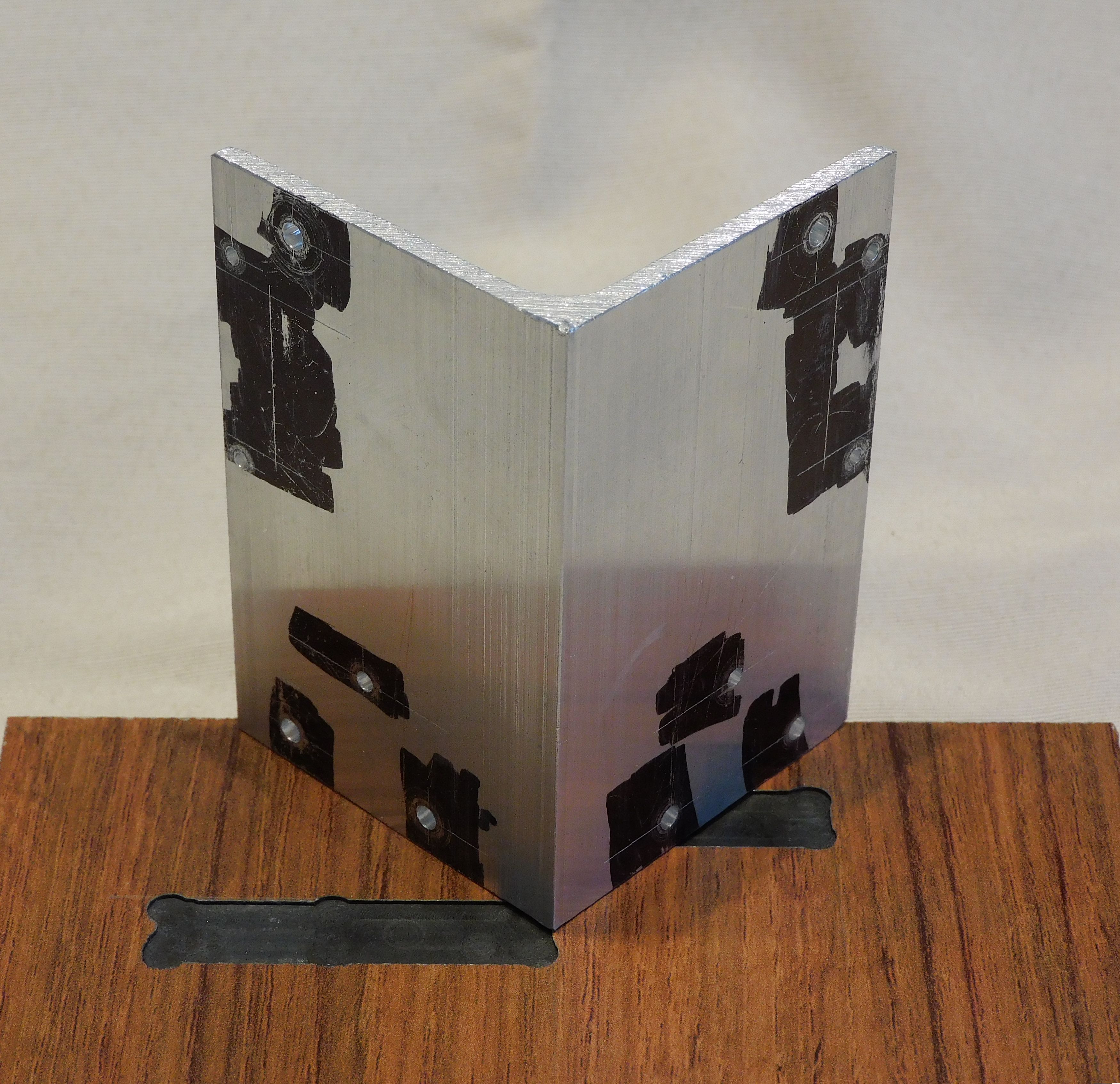 bracket with 12 holes drilled